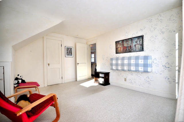 sitting room featuring light carpet