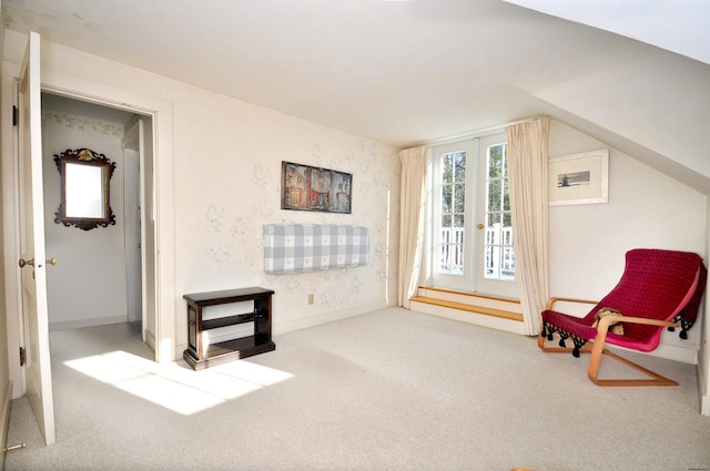 sitting room featuring lofted ceiling and carpet flooring