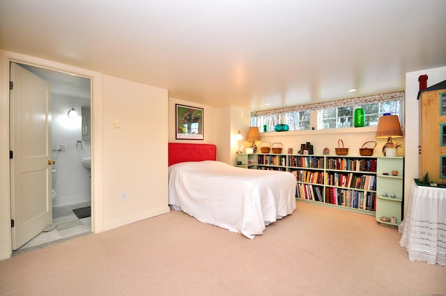 carpeted bedroom featuring ensuite bath