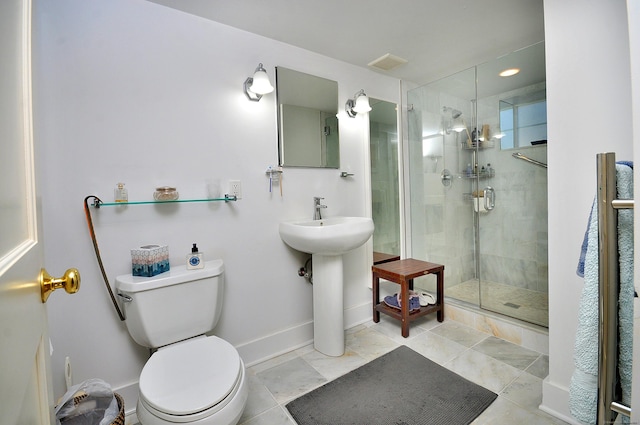 bathroom with sink, an enclosed shower, and toilet