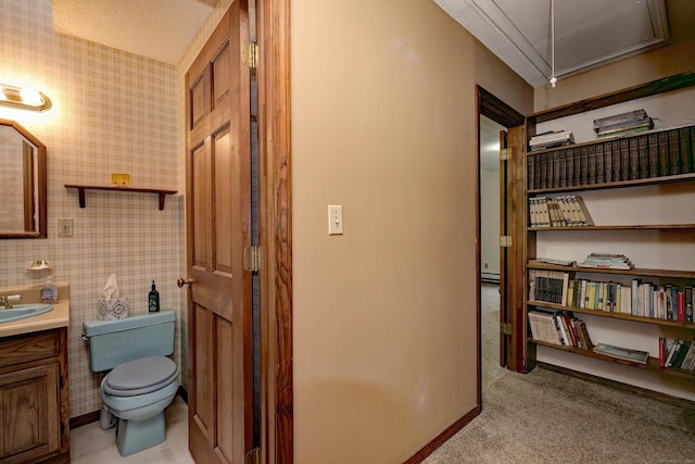 bathroom featuring vanity, a baseboard radiator, and toilet