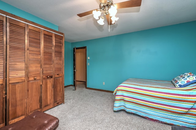 bedroom with light colored carpet, a closet, and ceiling fan