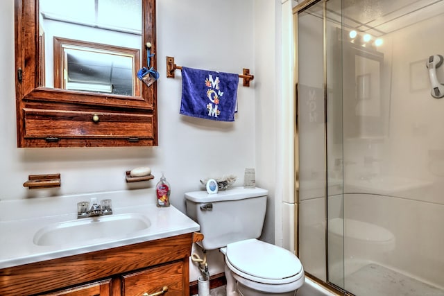 bathroom with vanity, toilet, and an enclosed shower