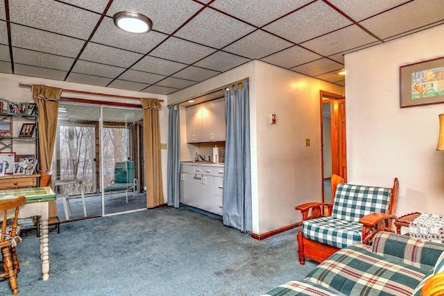 living room featuring a paneled ceiling and carpet floors