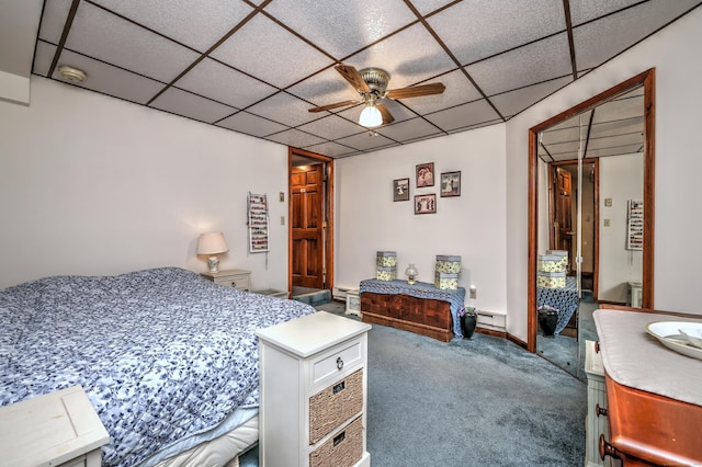 bedroom with ceiling fan, carpet flooring, a drop ceiling, and baseboard heating