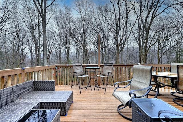 wooden terrace with an outdoor living space