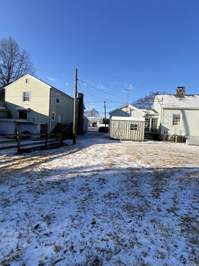 yard layered in snow featuring cooling unit