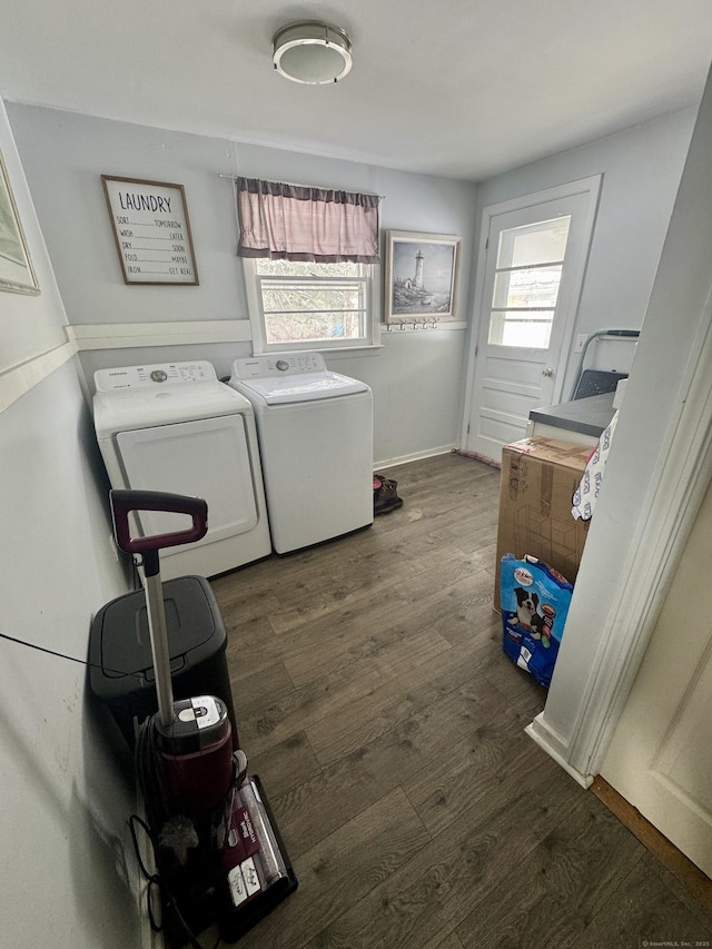 laundry room with dark wood-type flooring and washer and dryer