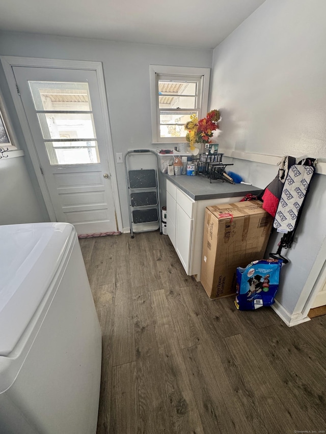 laundry area featuring cabinets, wood-type flooring, and washer / dryer