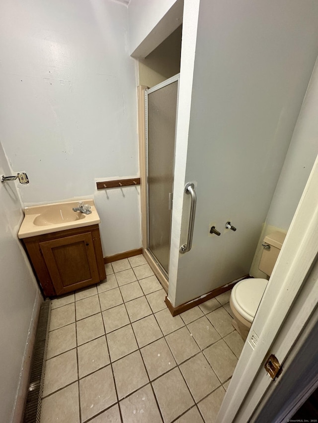 bathroom with tile patterned flooring, toilet, vanity, and a shower with shower door