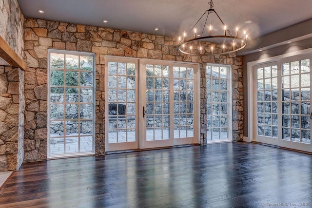 interior space with an inviting chandelier and dark hardwood / wood-style floors