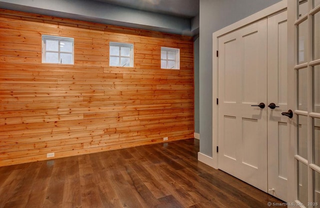 interior space featuring wooden walls and hardwood / wood-style floors