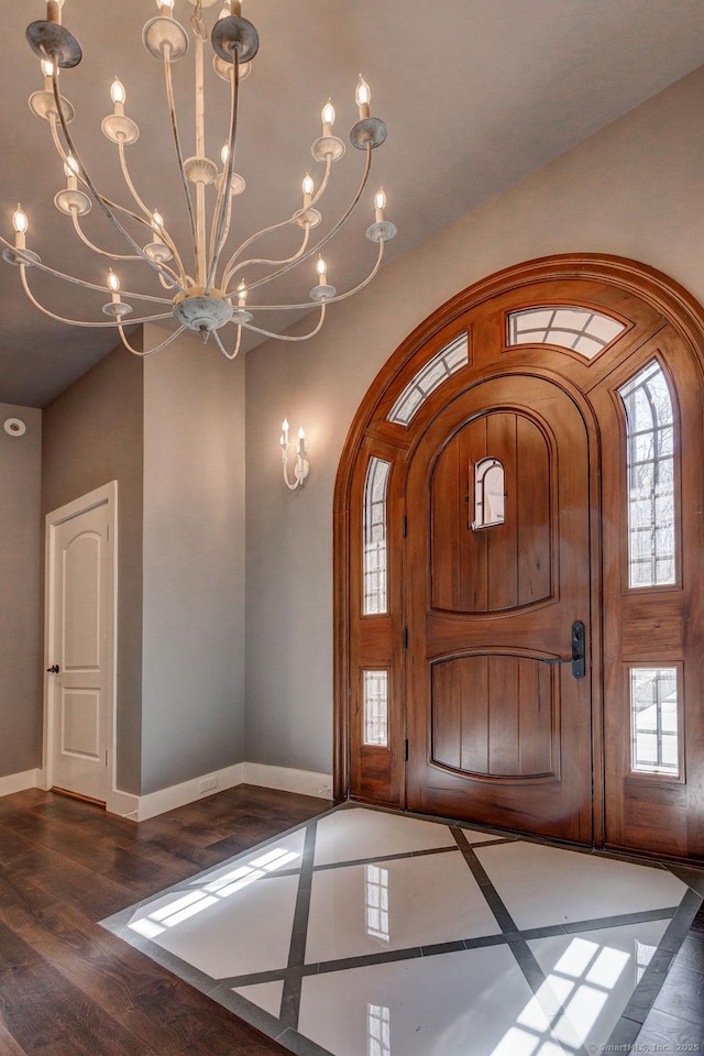 entrance foyer with a notable chandelier and dark hardwood / wood-style floors