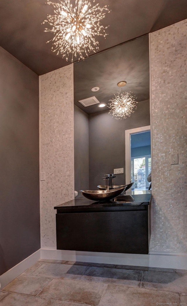 bathroom with an inviting chandelier and sink