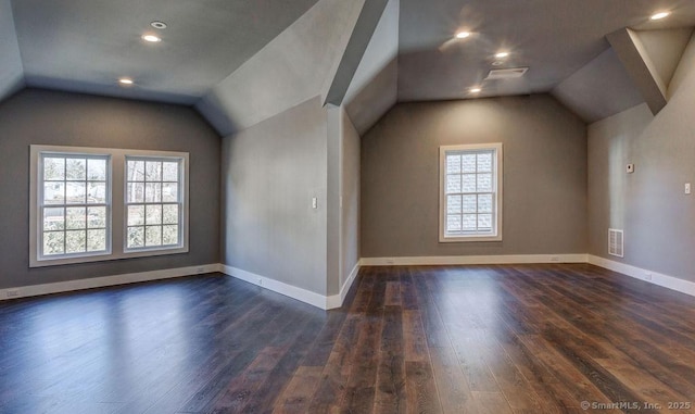 bonus room featuring dark hardwood / wood-style flooring and vaulted ceiling