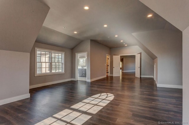 bonus room featuring lofted ceiling and dark hardwood / wood-style floors