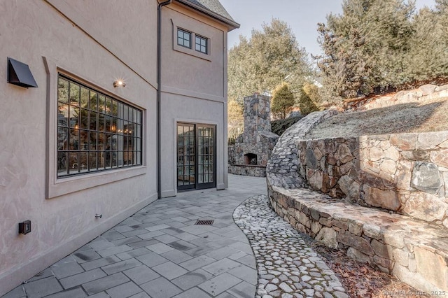 view of patio featuring an outdoor stone fireplace