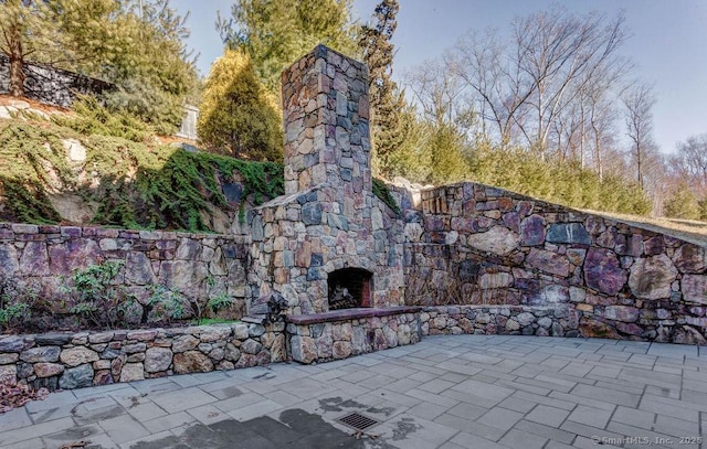 exterior space with an outdoor stone fireplace