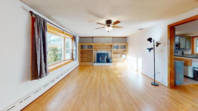 unfurnished living room featuring a baseboard radiator, ceiling fan, and light hardwood / wood-style floors