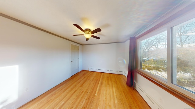 unfurnished room featuring a baseboard radiator, ornamental molding, ceiling fan, and light hardwood / wood-style floors