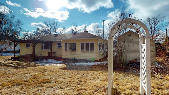 rear view of house featuring a yard