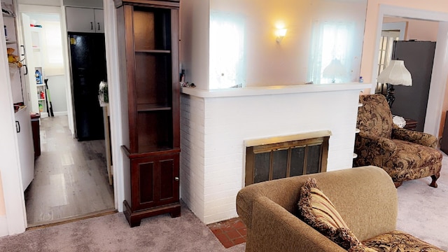 living room with a brick fireplace