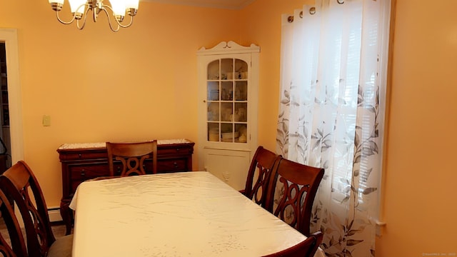 dining area featuring a chandelier and baseboard heating