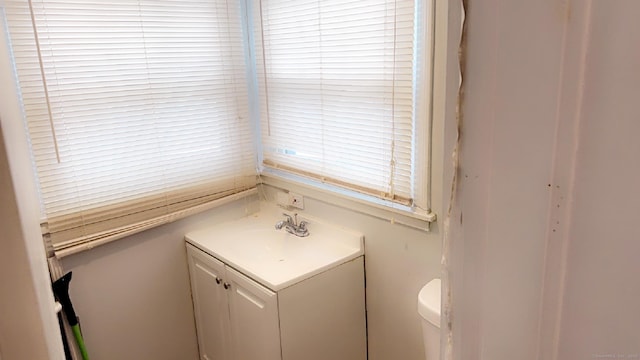 bathroom featuring vanity and toilet