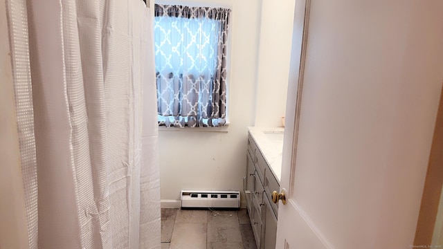 bathroom with vanity and baseboard heating