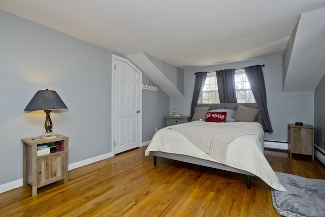 bedroom featuring a baseboard radiator and hardwood / wood-style floors