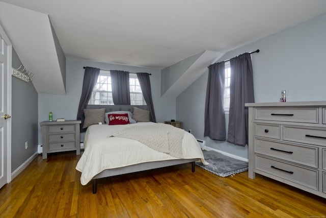 bedroom featuring dark wood-type flooring and vaulted ceiling