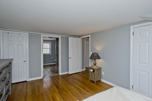 bedroom featuring dark wood-type flooring and a baseboard radiator