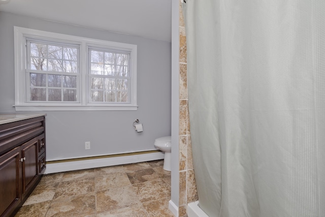 bathroom with a baseboard radiator, vanity, and toilet