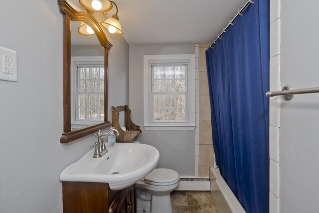 bathroom featuring vanity, toilet, and a baseboard heating unit