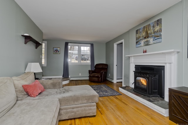 living room with baseboard heating and wood-type flooring