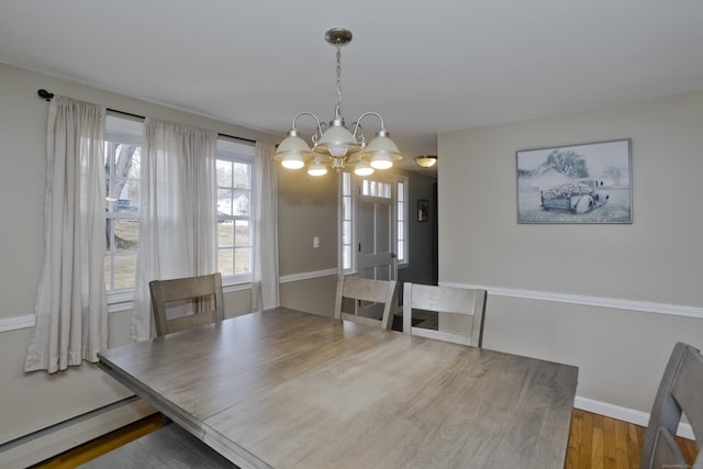 dining room featuring baseboard heating, a chandelier, and hardwood / wood-style flooring