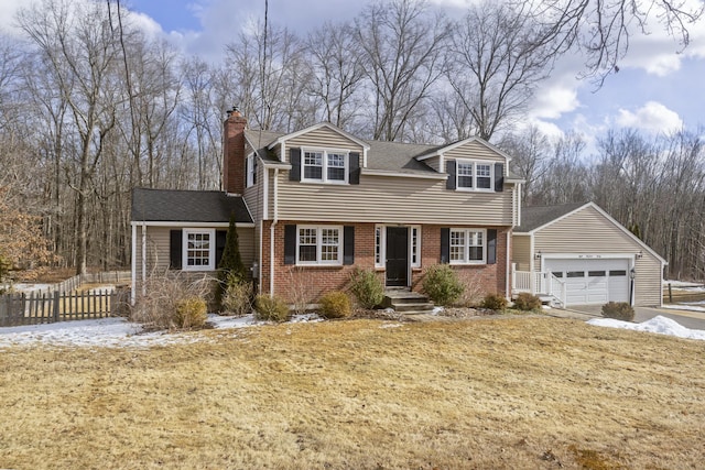 new england style home with a garage and a front lawn