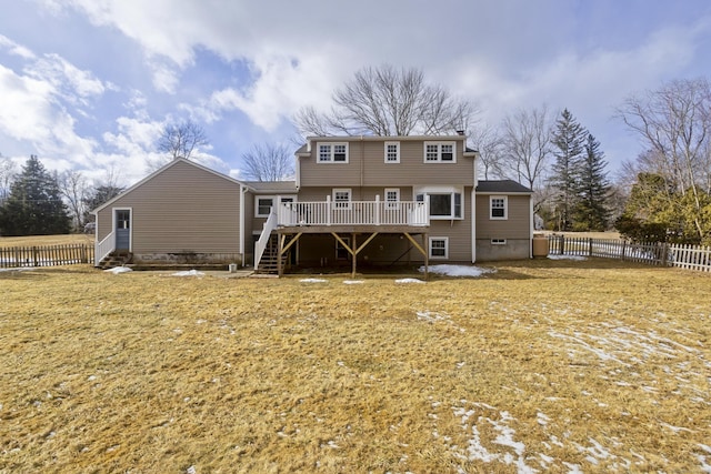 back of property with a wooden deck and a yard