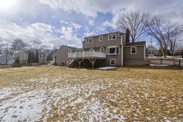 snow covered property with a wooden deck