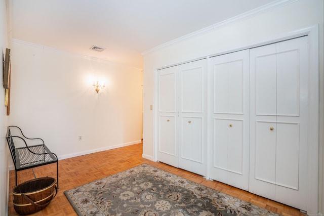 living area with crown molding and light parquet floors