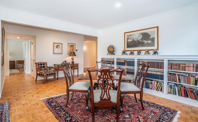 dining room with light parquet floors and ornamental molding