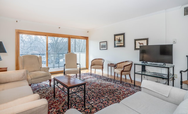 living room featuring hardwood / wood-style flooring and ornamental molding