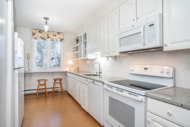 kitchen with tasteful backsplash, sink, white cabinets, a baseboard heating unit, and white appliances