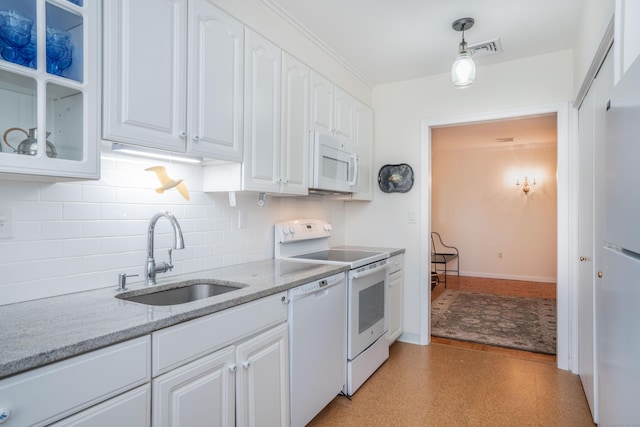 kitchen featuring sink, light stone counters, pendant lighting, white appliances, and white cabinets