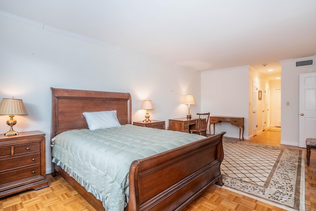 bedroom with crown molding and light parquet flooring