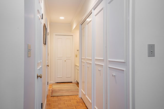 hallway with ornamental molding and light parquet floors