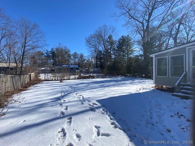 view of yard layered in snow