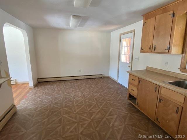 kitchen featuring sink and baseboard heating