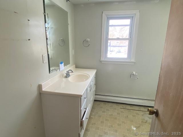 bathroom featuring a baseboard radiator and vanity