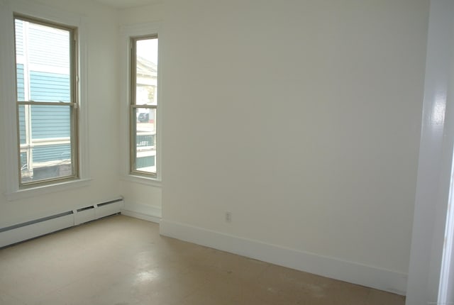 spare room featuring baseboards and baseboard heating